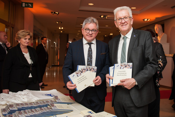 Europa Neujahrsempfang in der Landesvertretung in Brüssel Ministerpräsident Winfried Kretschmann (r.) und der Minister der Justiz und für Europa, Guido Wolf (M.), mit dem Europa-Leitbild der Landesregierung (Bild: © Vertretung des Landes Baden-Württemberg bei der Europäischen Union/FKPH)
