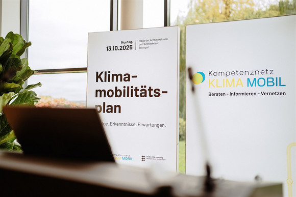 Zwei leuchtende Stellwände am Informationsstand des Kompetenznetz Klima Mobil zum Instrument Klimamobilitätsplan. 