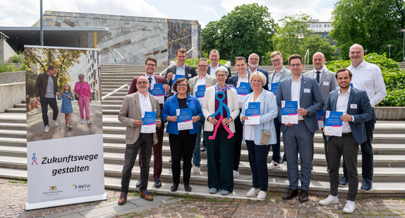 Gruppenfoto der teilnehmenden Städte und Gemeinden mit Staatssekretärin Elke Zimmer